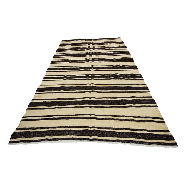 Handwoven striped vintage kilim rug from Afyon region of Turkey. Approximately 45-55 years old. In very good condition