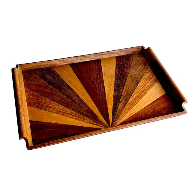 Offered is a vintage inlaid exotic wood tray with handles. The marquetry work resembles a Sunrise pattern, with the mixed...
