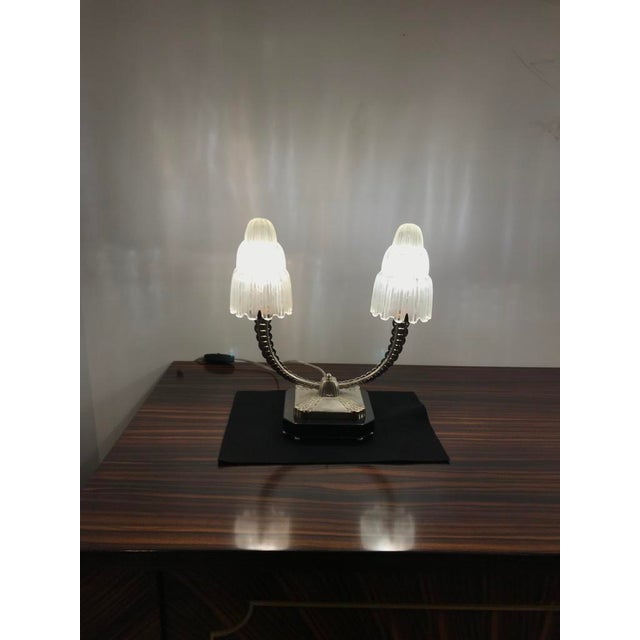 A stunning pair of French Art Deco table lamps created in the 1930s by Marius Ernest Sabino, (1878-1961). The shades are...