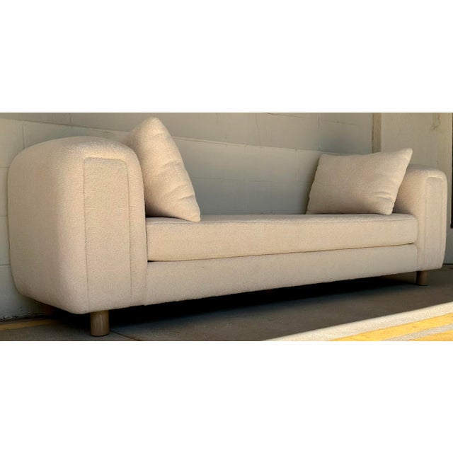 Original retail $2181, stylish Modern Oversized Cream Faux Sheepskin Bench, cerused oak finished wood legs, showroom floor...