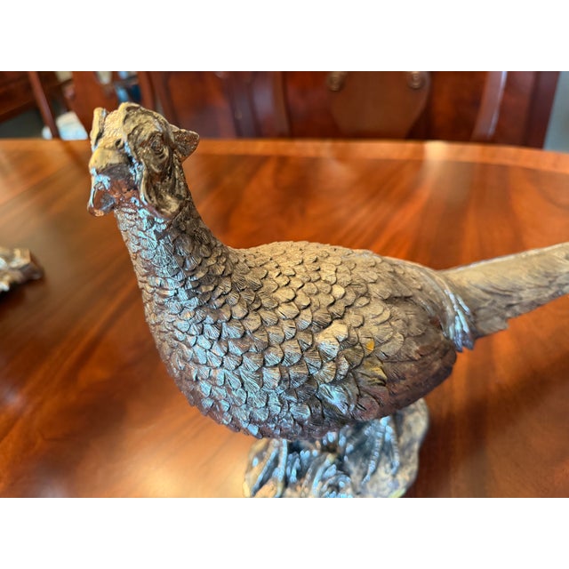 One pheasant has small chip on ear. Add timeless elegance to your décor with this Antique Silver Resin Pheasant Pair....