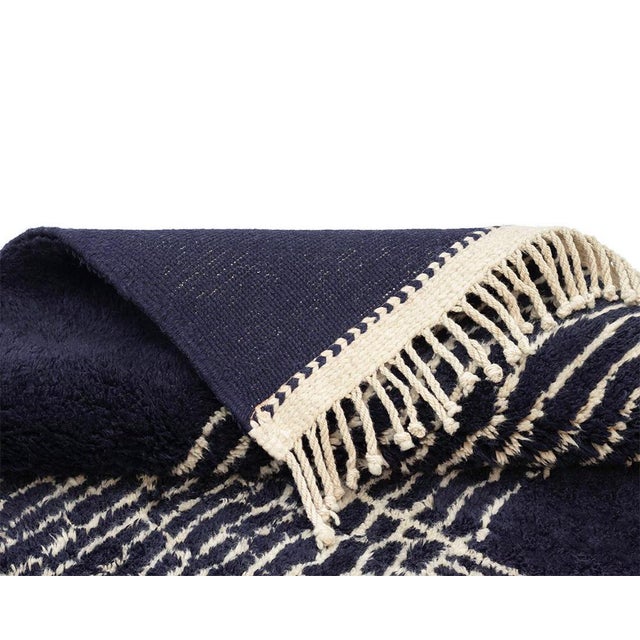 Contemporary Hand-knotted wool rug with a bold contrast of dark night Blue and Ivory, featuring abstract line work for a...