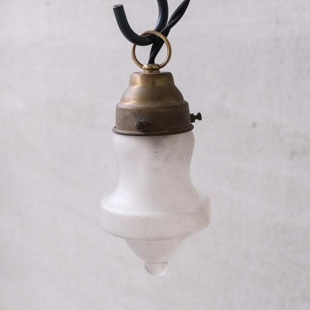 Very small pendant lights. France, c1950s. Naturally patinated brass galleries with opaque glass shades. Re-wired and PAT...