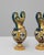 This pair of 20th Century Italian painted ceramic vases showcases the vibrant artistry and classical influences...