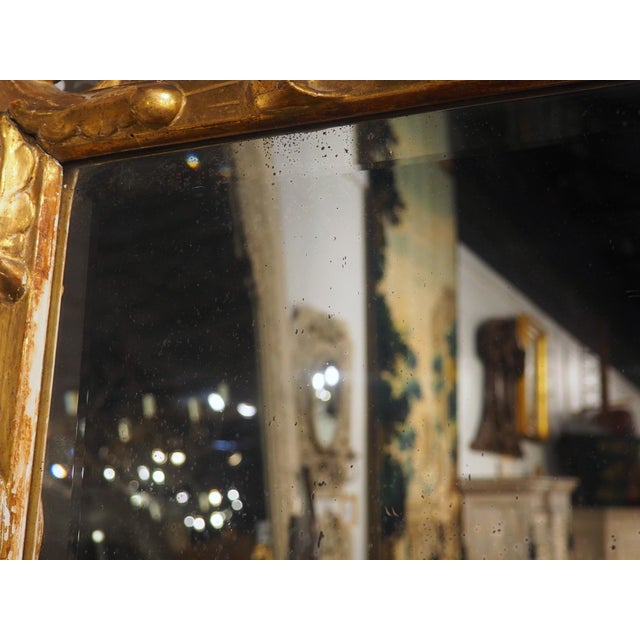More information coming soon… A magnificent giltwood mirror from the 1800s with beveled glass. The large foliage that...