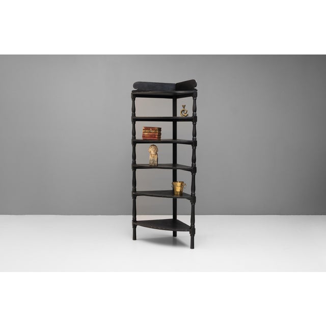 Pine corner unit with curved front shelves in original black paint finish. Circa 1850.