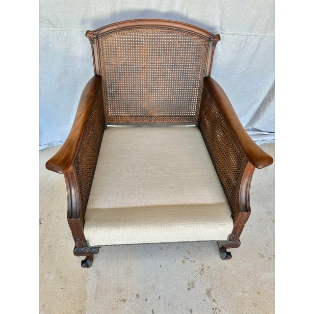 This Early 20th Century French Style Lounge Chair was crafted in the early 1900's from walnut and cane. The armchair...