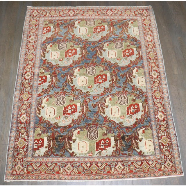 A scattter size Persian Senneh Rug with a "gol farang" floral design