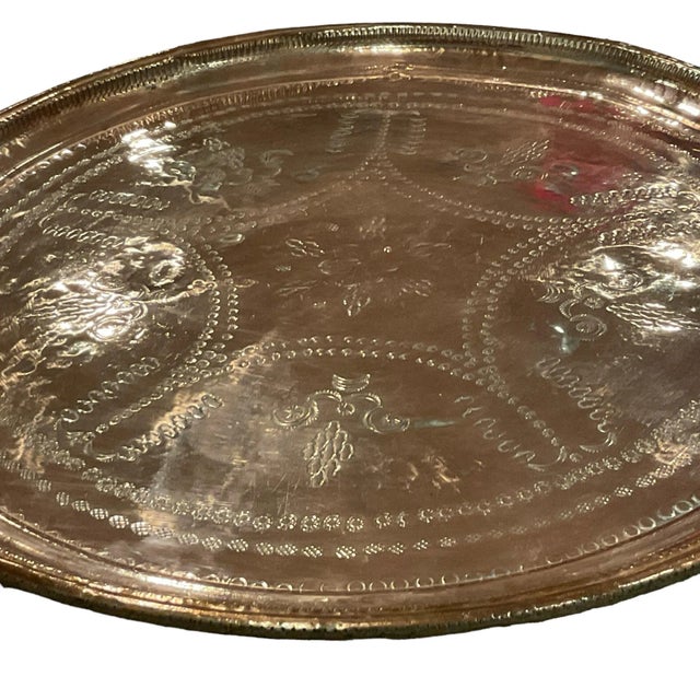 Large stamped heavy copper mix tray, at 25.5”. It can be used as a tray, a table top, or a wall hanging. It has a hanger...