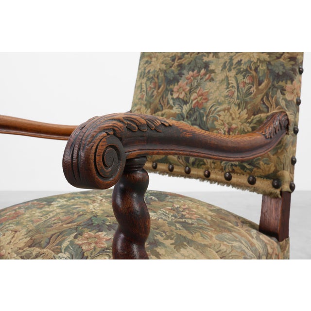 A distinguished 17th‑century English armchair crafted in rich walnut and upholstered in a traditional tapestry fabric....