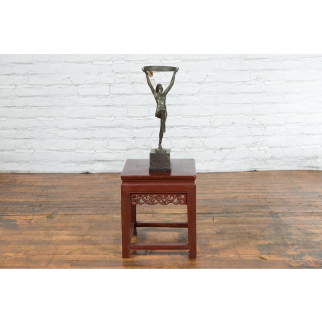 A vintage Art Deco style bronze table lamp on marble base from the mid 20th century depicting a dancer holding a ring with...