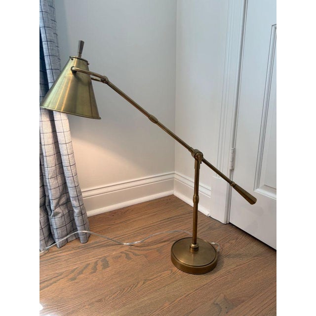 Hand rubbed antique brass table lamp featuring a single screw hinge detail. An attractive brass shade completes the look....