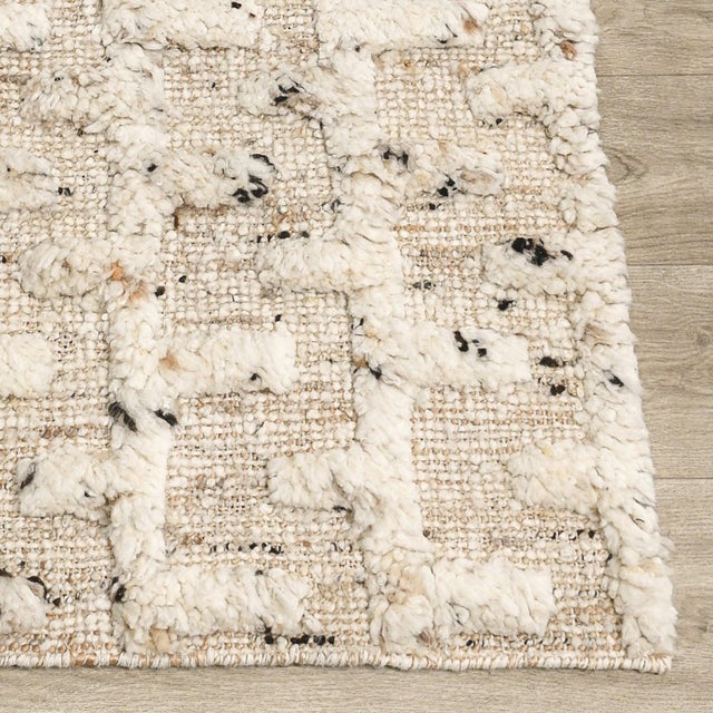 Jute rug with soft high piled wool in a rhythmic abstract brick-like pattern. Flecks of black add an organic, almost...