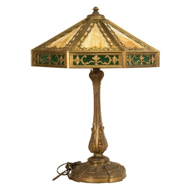 A fine, large antique American Arts & Crafts slag glass and brass table lamp, by The Miller Lamp Company, circa 1910. This...