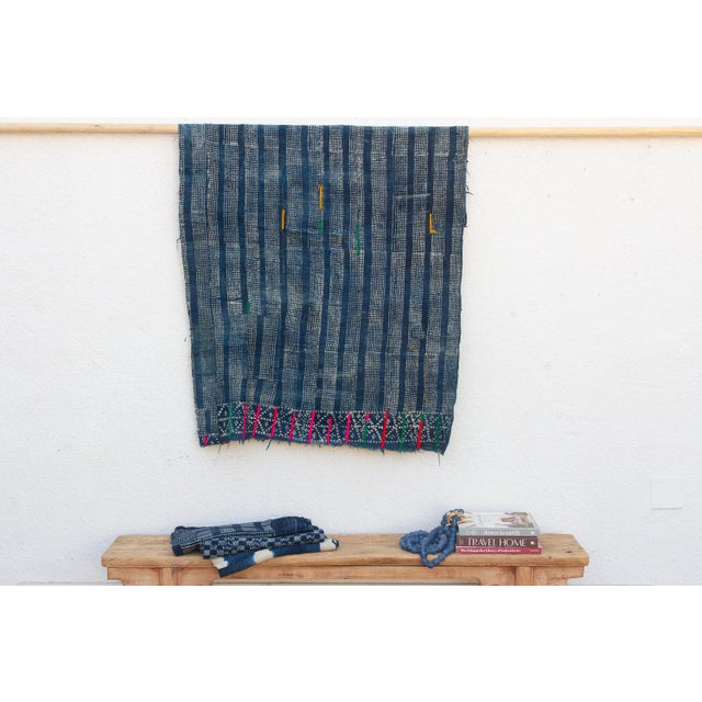 A masterwork of Malian textile heritage featuring deep indigo saturation and symbolic geometric motifs. Originating from...