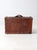 This early 20th-century antique leather suitcase features rich brown leather, brass hardware, a leather handle, and worn...