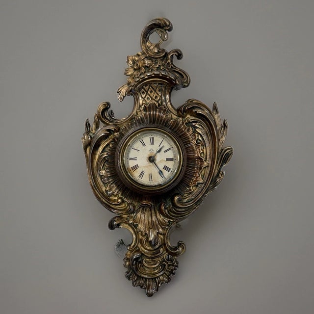 This listing is for an antique Ansonia novelty clock. The clock takes the form of a miniature cartel clock. Several...