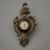 This listing is for an antique Ansonia novelty clock. The clock takes the form of a miniature cartel clock. Several...
