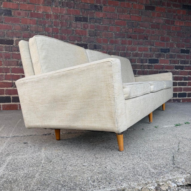 Early Florence Knoll model 26 sofa. Wood legs, three seats and 90” long for reupholstery.