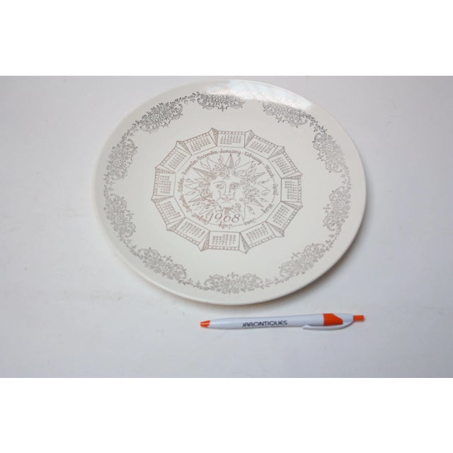 Vintage porcelain collector's plate representing the year 1968. Features hand-painted central sun decoration with monthly...