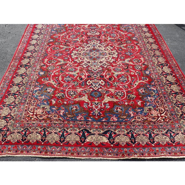 Measures: 7'8 x 11'2 Vintage Persian Isfahan Rug with Red Field and Ivory Medallion Design. Keivan Woven Arts/...