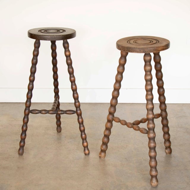 Vintage wood stool with beautiful wavy wood legs from France. Circular seat with unique carved ring detail on top....