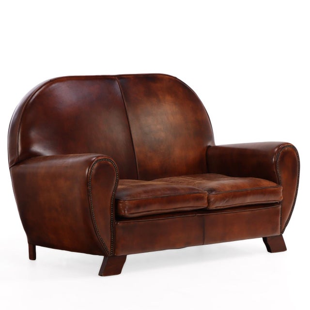 A sculptural two-seat leather loveseat executed in the manner of 1930s Dutch and Scandinavian modernist design. The...