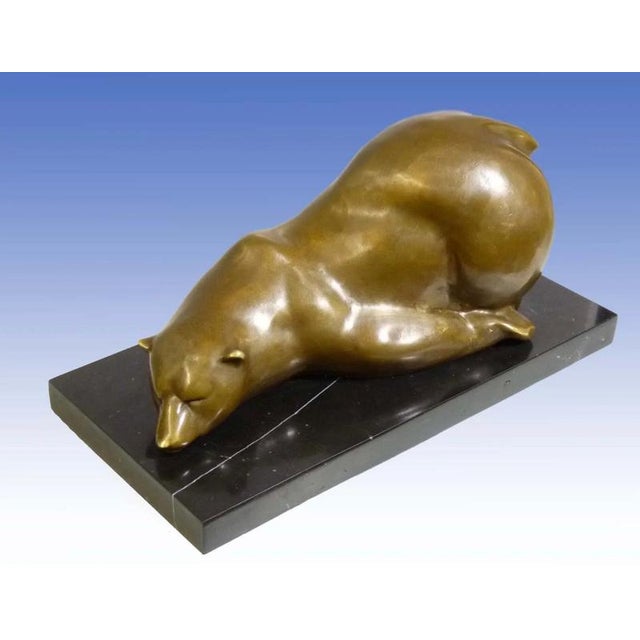 This large animal bronze statue represents a polar bear resting on its belly. The piece is finished with a hand-applied...
