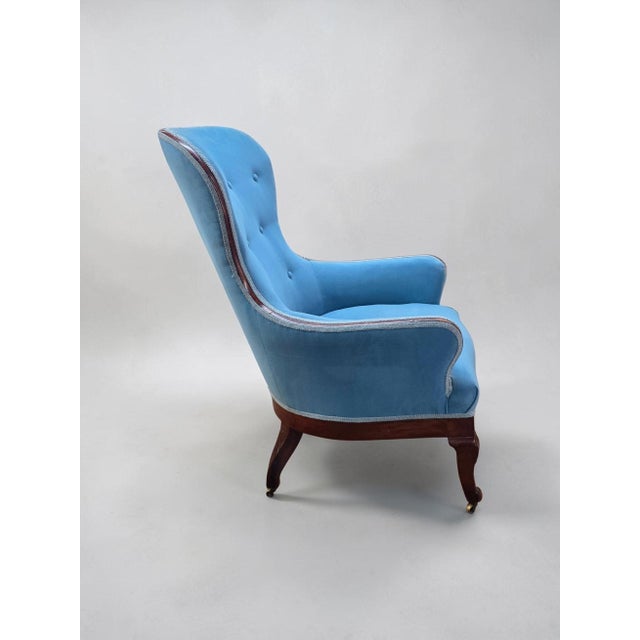 Elegant late 19th-century Chippendale Revival wingback easy chair, crafted in richly figured mahogany and distinguished by...