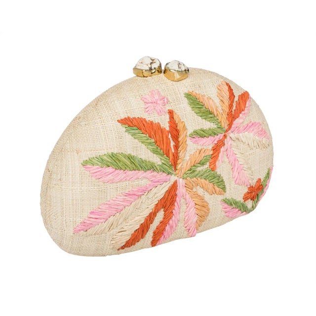 Dome clutch in natural raffia embroidered with multi color leaves. Ivory stone clasp closure. Lined with slip pocket and...