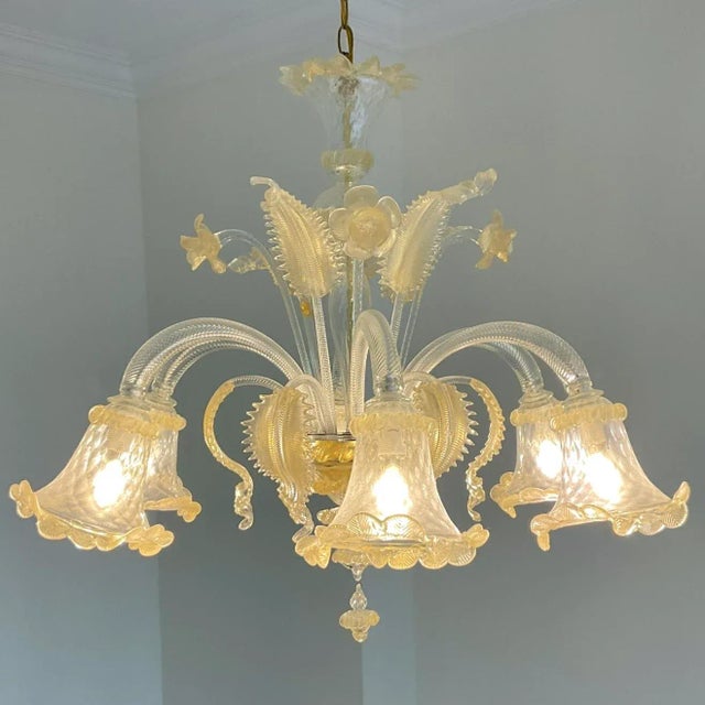 This vintage Italian glass floral chandelier, inspired by Murano, showcases exquisite craftsmanship and timeless beauty....