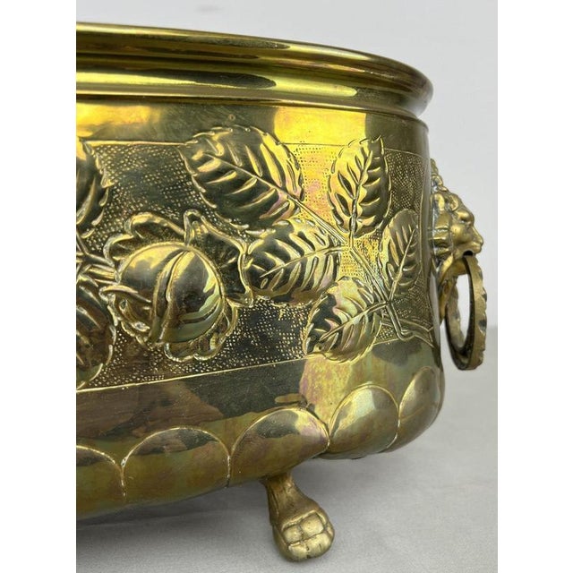 A striking Vintage brass decorative pot , featuring an oval form with elaborate raised floral and rose decoration,...