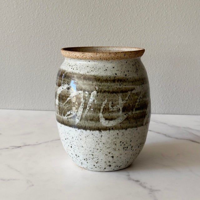Handmade studio pottery stoneware vase. Featuring neutral tones of speckled gray and an ombre green glazed middle.