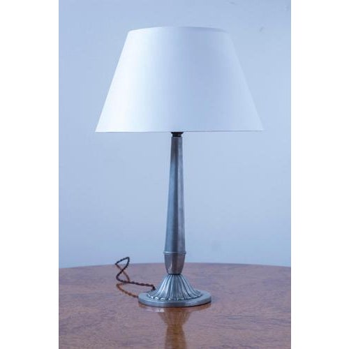 Swedish grace table lamp produced in Västerås, Sweden in 1931. Made from pewter with brass details. Lamp fitting with...