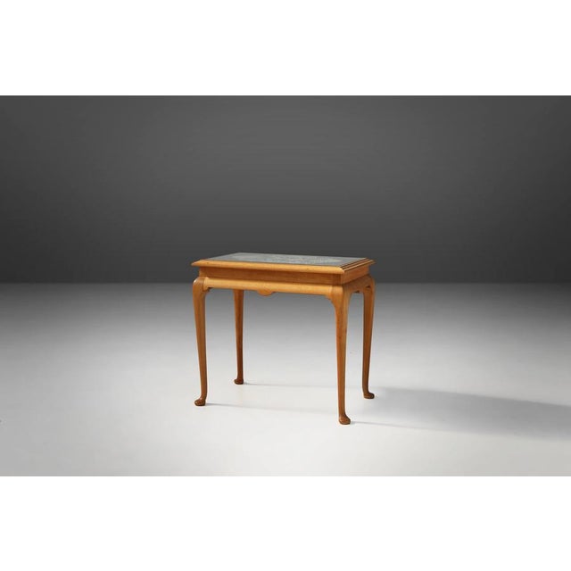 A charming and highly original French side table from the 1950s, crafted in beech wood with a glass top and a delicate...