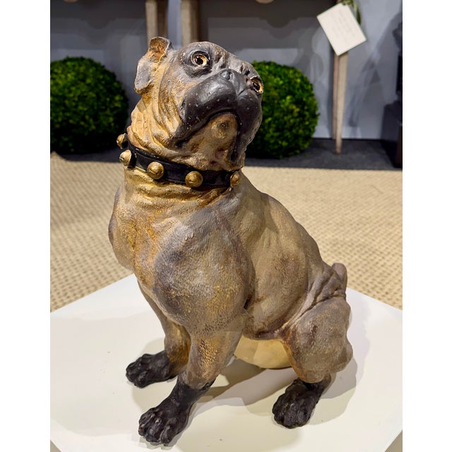 A large late 19th century English cold-painted terracotta model of a seated bulldog, with striking inset glass eyes and a...