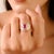 This elegant ring showcases an oval-cut ruby weighing 1 carat, surrounded by brilliant round and baguette-cut diamonds...