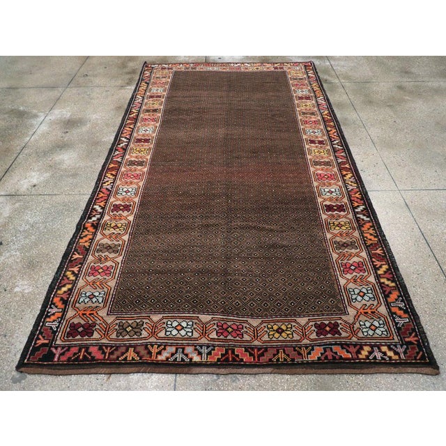 A vintage Turkish Anatolian tribal gallery carpet handmade during the Mid-20th Century. Measures: 6' 4" x 11' 7".