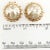 Vintage clip earrings in a classic button style embellished with faux pearls. The simulated mabe' pearl in the center is...