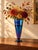 An impressive vintage Orient & Flume art glass vase with a luminous peacock-blue finish that glows as it catches the...