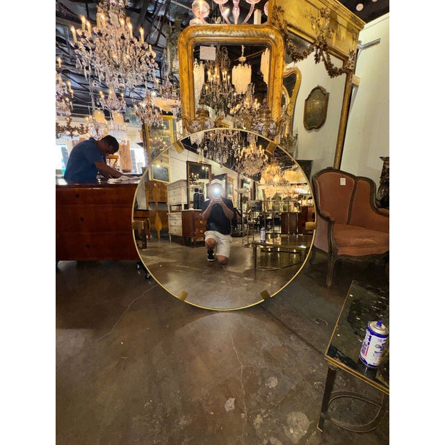 The Vintage Italian Heavy Brass Round Mirror is a stylish and unique piece perfect for any living room. With its round...
