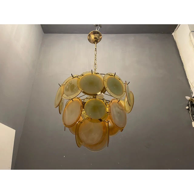 Murano glass disc chandelier 1980’s composed of 23 murano glass discs each disc is slightly different in size and color....