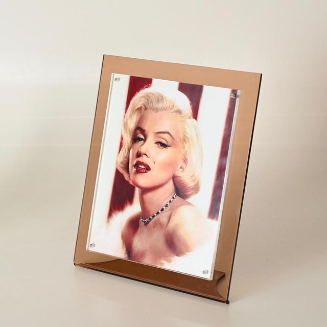 Wonderful large photo frame made from a single curved piece of smoked pink acrylic and completed with a thick clear...