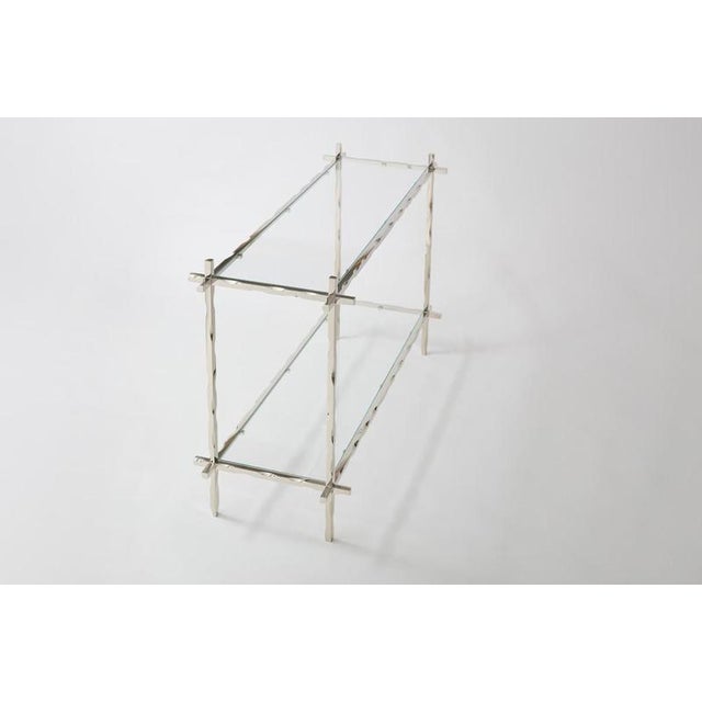 Geometric fluide side table by jennifer midoz dimensions: d 125 x w 47,5 x h 81 cm materials: white nickel-polished brass....