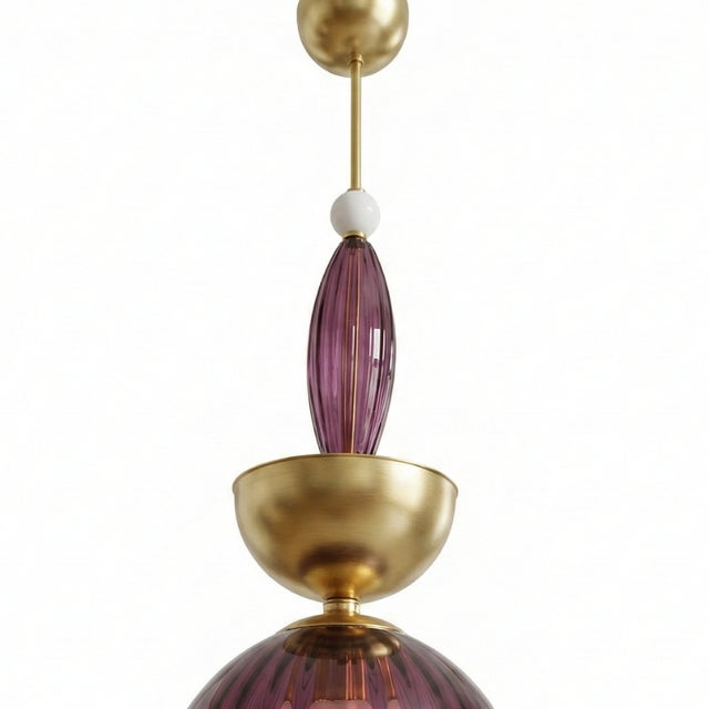 Its vertical structure combines different pieces of hand-blown Murano glass, highlighting a large lower cup in a beautiful...