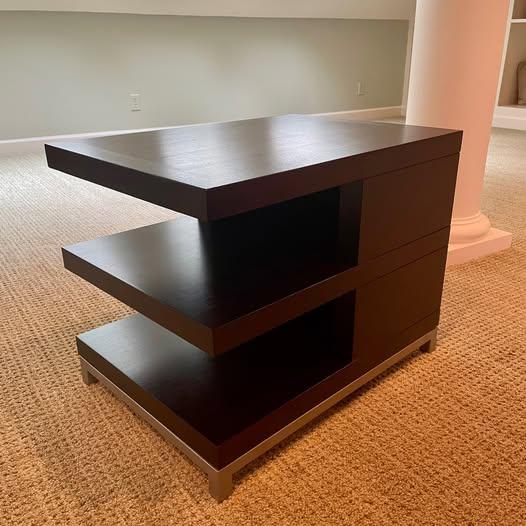 Beautiful, modern, pair of three-tier end tables featuring classic lines and a timeless architectural silhouette. Each...