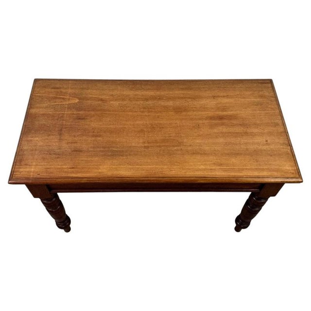 A handsome early 20th-century English side table, finely crafted from oak and distinguished by its substantial...