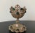 A beautiful brass filigree egg holder, circa 19th century, Turkey. Green gems adorn the egg holder and complement the warm...