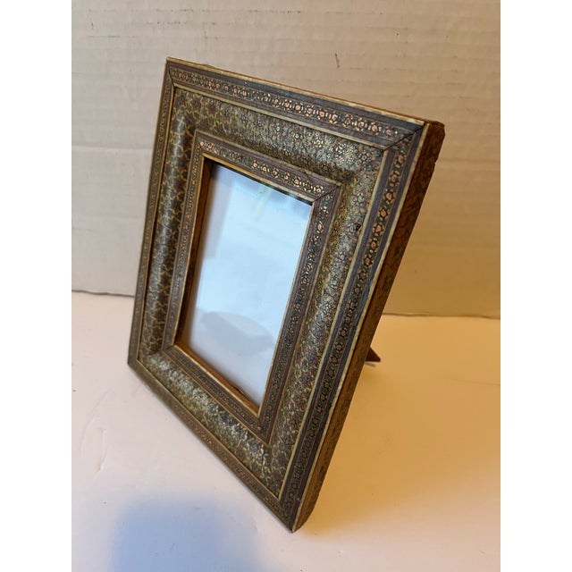 A single vintage rectangle wood micro mosaic inlaid picture frame finished with glass and standing back. Opening measures...