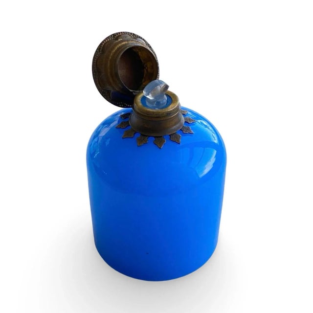 This exquisite 19th-century French scent bottle is a rare treasure of Parisian artistry. Hand-blown from luminous blue...